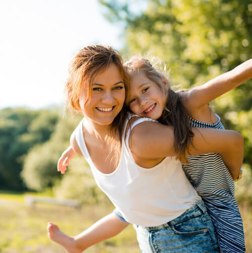 Home page Happy siblings outdoors on a summer day. Piggyback ride fun. Serene Dentistry of North Salt Lake Dentist in Salt Lake City Ut. Dr. Will Bates