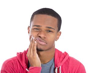 young man holding face