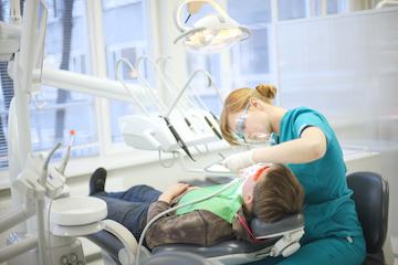 Dental hygienist cleaning teeth